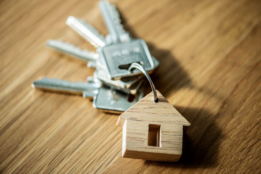 House keys with a small wooden house charm